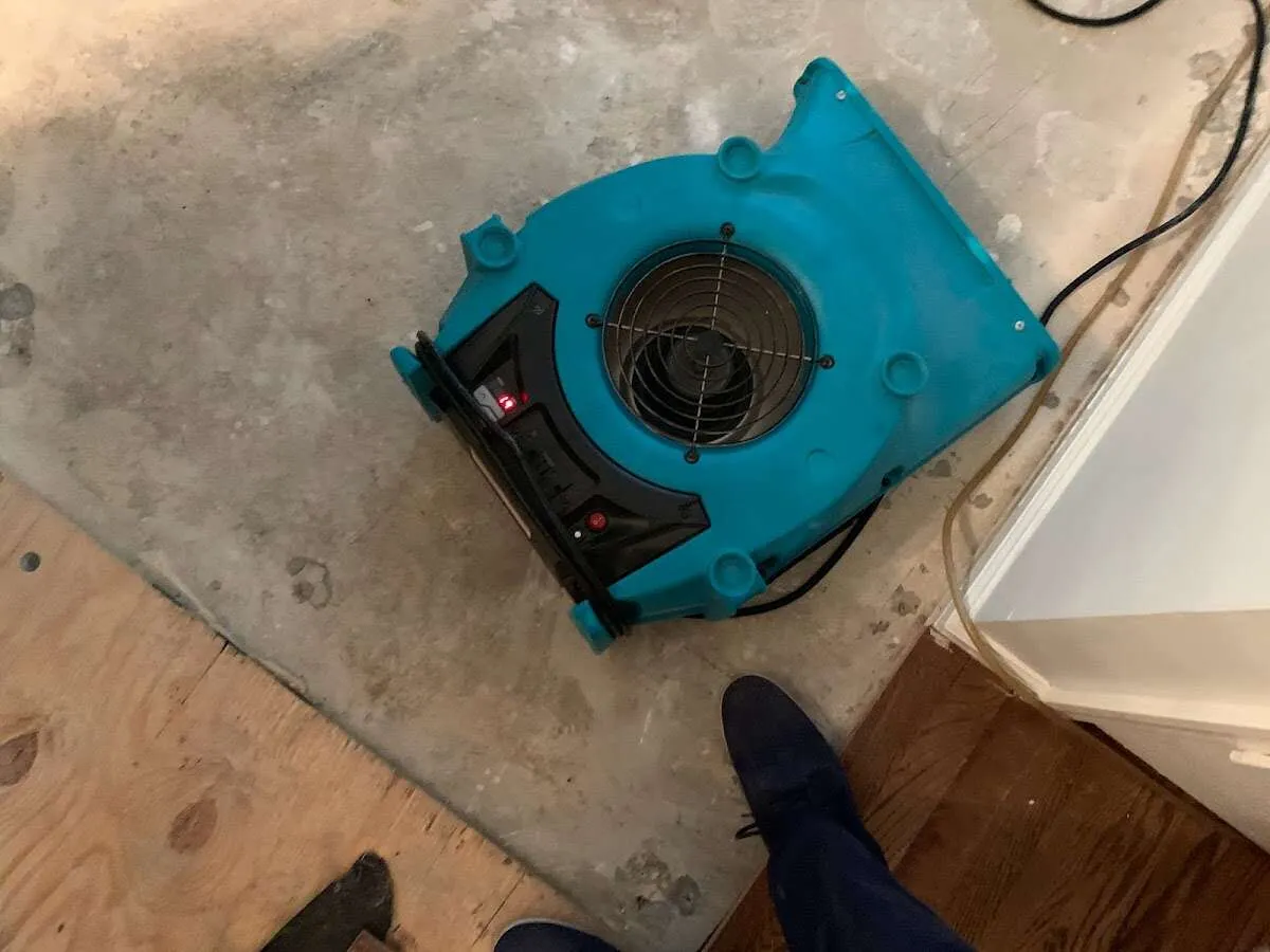 Air mover drying subfloor during Commercial Water Damage Restoration in Joliet